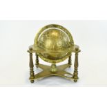 A Vintage Solid Brass Globe Decorative globe with zodiac engraved equator ring and x frame base.
