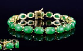Chinese Green Jade Tennis Bracelet, 40cts of oval cut cabochons of green jade,
