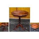 A Decorative Occasional Table, raised on a turned base with trefoil legs. highly polished inlaid top