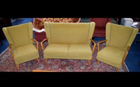 A Mid Century Scandinavian Style Three Piece Suite Comprises wing back generous two seater sofa and