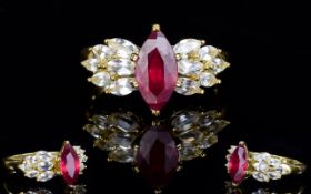 Ruby and White Topaz Ballerina Style Ring, a 3ct marquise cut ruby flanked by 1.