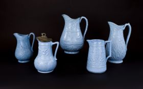 Five Various Aesthetic Period Blue Moulded Jugs,