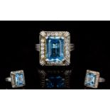 Ladies Silver Swiss Blue And White Topaz Dress Ring The central step cut brilliant blue central