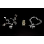 Two White Metal Charm Bracelets and a Silver Whistle, the larger curb chain bracelet with one