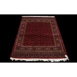 A Large Silk Rug Bokhara Rug on red ground with repeated lozenge design. Dimensions, 1.90 x 1.