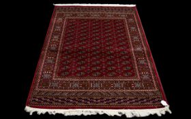 A Large Silk Rug Bokhara Rug on red ground with repeated lozenge design. Dimensions, 1.90 x 1.