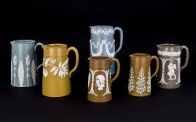 Six Various Jasper Style Moulded Earthenware Jugs comprising two Harvest jugs,