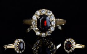 9ct Gold Set Diamond and Ruby Cluster Ring. Flowerhead Setting, The Central Ruby Surrounded by 12