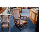 Antique Rocking Chair Of Plain form with spindle arm rests, upholstered in dove grey chenille.