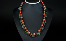 A Pair Of 1920's Handmade Glass Bead Necklaces Two in total each comprising striated glass beads