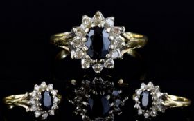 9ct Gold Set Diamond and Sapphire Cluster Ring. Flowerhead Setting. The Central Sapphire