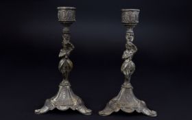 A Pair Of Vintage French Cast Iron Candlesticks Two small footed candlesticks with figurative