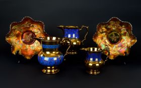 Set of Three Copper Lustre Ware Graduating Jugs together with two Carnival glass bowls.