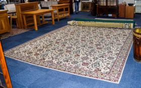 A Very Large Woven Wool Rug Cream Large rectangular rug with cream ground and repeated red, yellow.