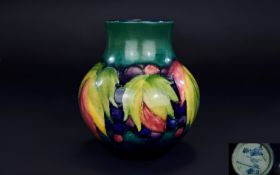 W. Moorcroft Signed Tube lined Globular Shaped Vase ' Leaf and Berry ' Pattern on Blue / Green