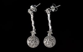 Pair of Diamond Cluster Drop Earrings, .75ct round clusters of baguette cut diamonds suspended