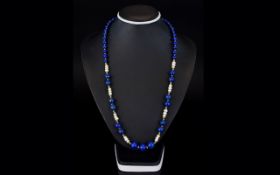 Lapis And Freshwater Pearl Necklace Long necklace strung with multiple spherical Lapis beads,