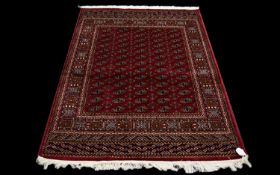 A Large Silk Rug Bokhara Rug on red ground with repeated lozenge design. Dimensions, 1.90 x 1.40 M