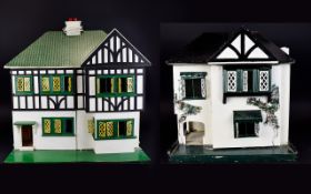 Two Two Tier Wooden Constructed Tudor Style Dolls Houses with a small amount of furniture.