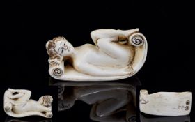 Antique Ivory Erotic Netsuke Finely carved in the form of a recumbent nude female figure lying on a