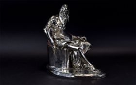 A Chromed Figure In The Form Of A Pensive Male Large silver tone figure in the form of a seated