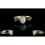 18ct Gold Set Single Stone ( Oval Shaped Opal )Dress Ring. The Opal of Very Pale Colour.