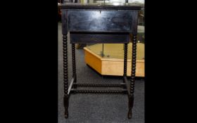 Antique Late 19th Century Writing Desk A small ebonised wood desk with turned legs and stretcher.