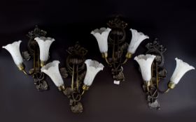 Four Reproduction Art Nouveau Wall Sconces Bronzed wall lights in floral whiplash form each with