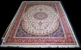 A Large Woven Silk Hekiz Carpet Finley woven rug on beige ground with intricate scrolling floral