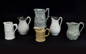 Collection of 19thC Rustic and Floral Moulded Jugs including a large grey/green jug showing a pair