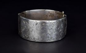 Elizabeth II Wide Hinged Silver Bangle with Stylish Floral Engraving to Front Panel.