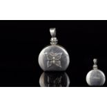 A Mexican Silver Decorative Perfume/Attar Pendant A small silver circular flask with flat base and