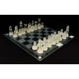 Modern Glass Chess Set Comprising of glass board and frosted and clear glass pieces.