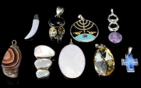 A Collection Of Silver And Mixed Metal Pendants Nine items in total, a varied collection to include,
