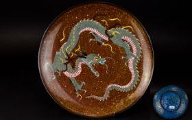 A Chinese Cloisonne Charger Circular decorative charger with central dragon motif in green, pink and