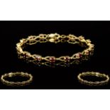 Ladies 10ct Gold Garnet Set Bracelet, Marked 10kt. Set with 15 Garnets, Good Safety Clasp.