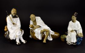 Three Oriental Figures A trio of earthenware figures each finished in white glaze, all in good