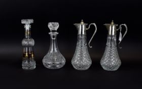 A Pair of Glass Claret Jugs 12 inches in height, together with two various decanters.