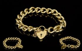 A Good Quality And Heavy 9ct Gold Curb Bracelet With Attached Safety Chain And Heart Shaped 9ct