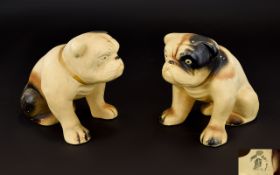 A Pair Of Vintage Ceramic Bulldog Figures Two unglazed earthenware figures in the form of seated
