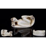 Antique Ivory Erotic Netsuke Finely carved in the form of a recumbent nude female figure lying on