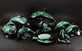 A Collection Of Green/Black Blue Mountain Ceramic Marine Figures comprising of four dolphins, two