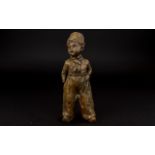 Early 20th Century Cast Metal Figure In the form of a young boy in 19th century dress. Aged