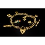 Antique 9ct Curb Bracelet Loaded with 8 9ct Gold Charms with Safety Chain and Padlock,