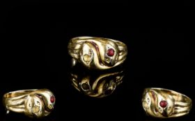 A 9ct Gold Snake Eternity Ring In the form of two interlocked snakes with stone set heads.