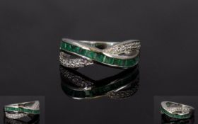 Emerald and Natural White Zircon Cross Band Ring, a row of channel set, square cut emeralds crossing
