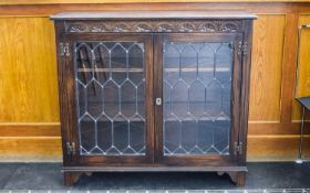 Oak Jacobean Style Carved Bookcase, leaded glazed front with 2 shelves. 36 inches high, 39 inches