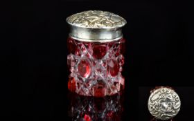 An Edwardian Silver And Cut Glass Rouge Pot Miniature faceted cranberry glass cylindrical pot with