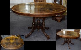 Victorian Walnut Inlaid Table. Oval Tilt Top On Quatrefoil Base. 33 x 47 Inches, Height 28 Inches