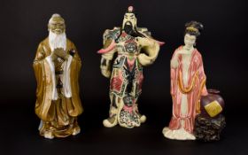 Three Decorative Oriental Figures The first, a resin figure in the form of a Japanese emperor with